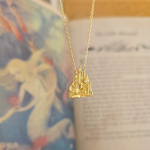 Gold necklace with a mermaid castle pendant 